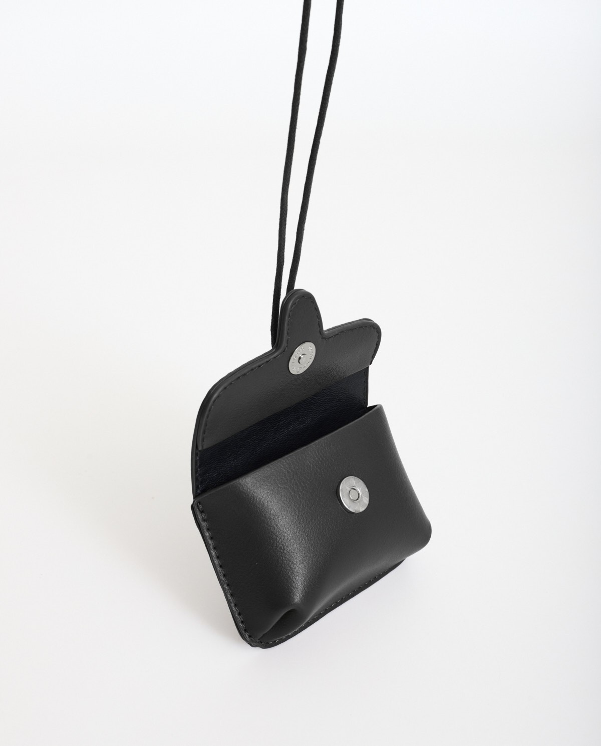Black rigid mini wallet by Yerse with snap-button closure and removable neck strap 4