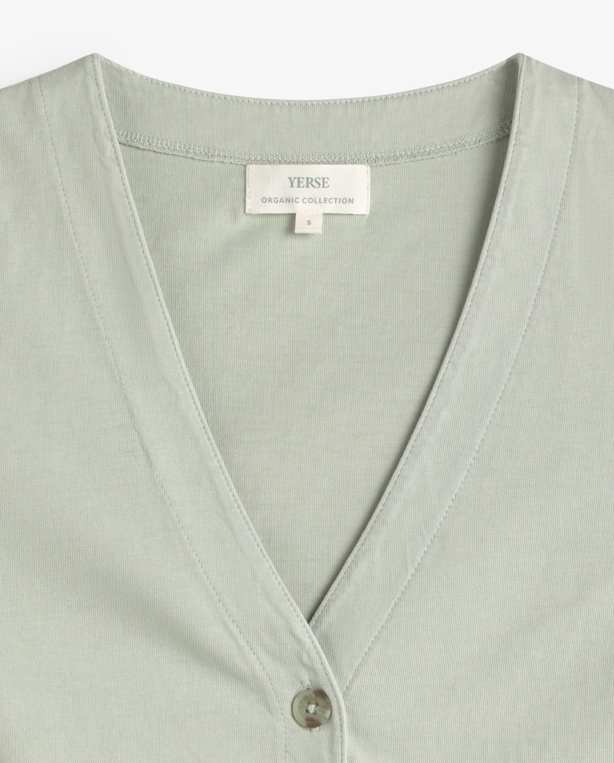 Chaleco de punto algodón orgánico en color verde aguamarina, vista frontal con detalle del tejido 5