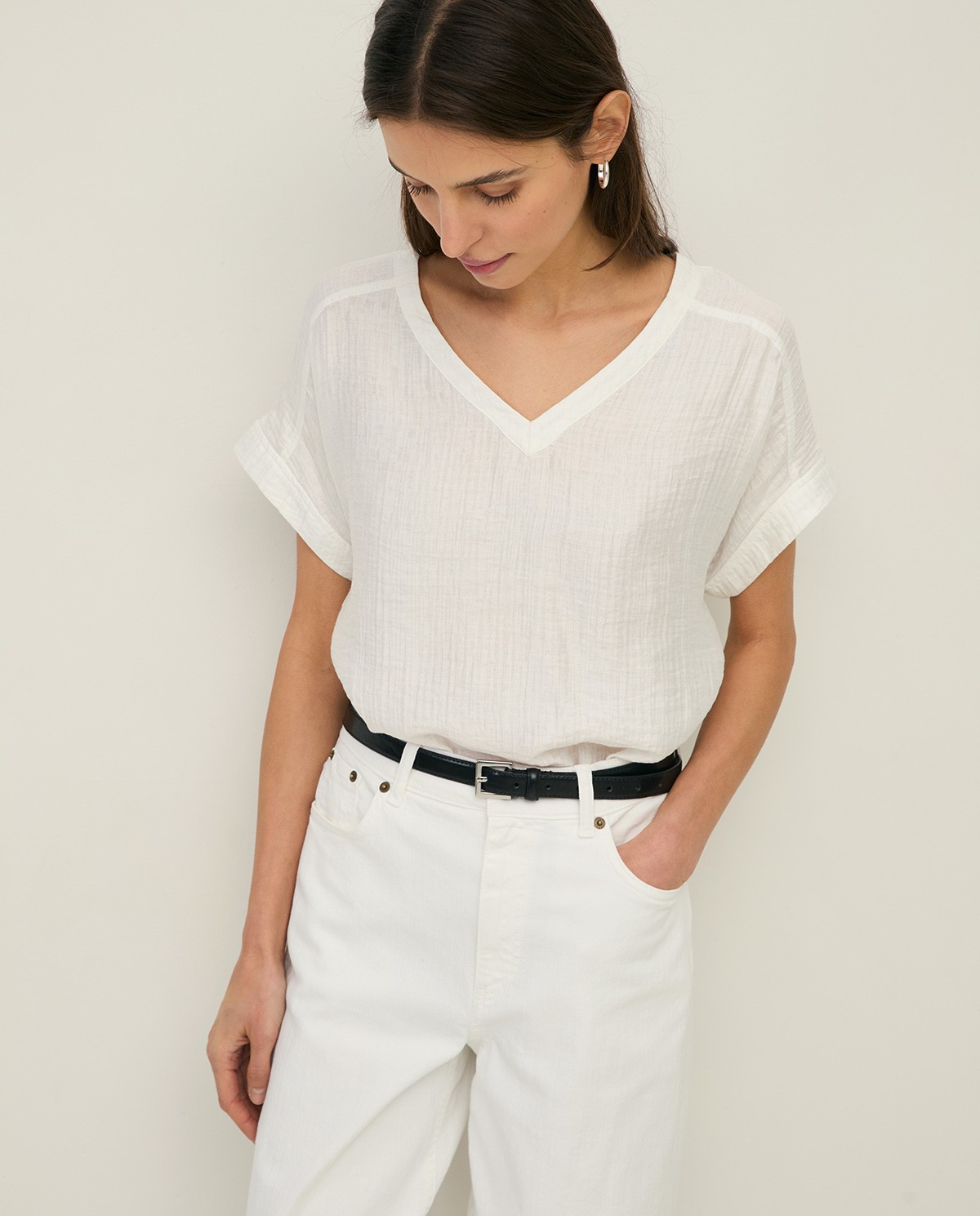 Blusa cuello pico efecto arrugado en color crudo, vista frontal con detalle del tejido