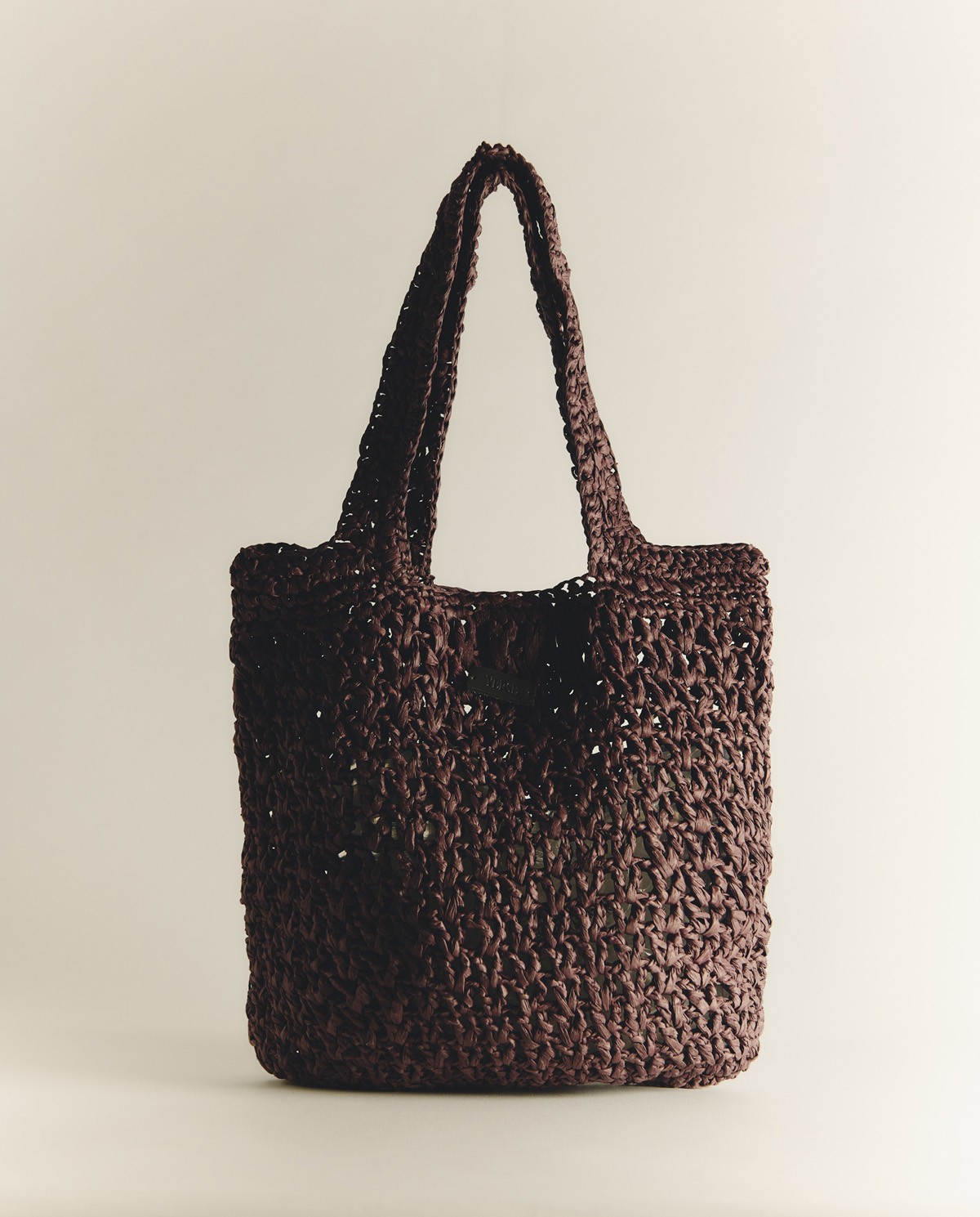 Bolso tote handmade de rafia en color chocolate, vista frontal con detalle del tejido 2