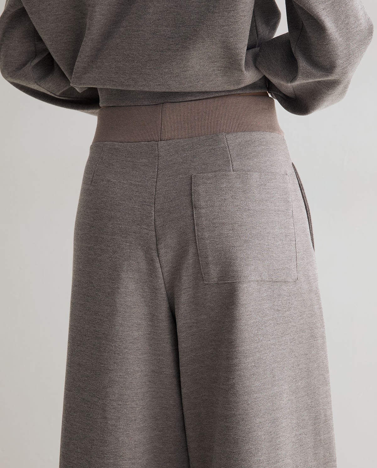 Pantalones punto wide leg en color gris, vista frontal con detalle del tejido interlock 4