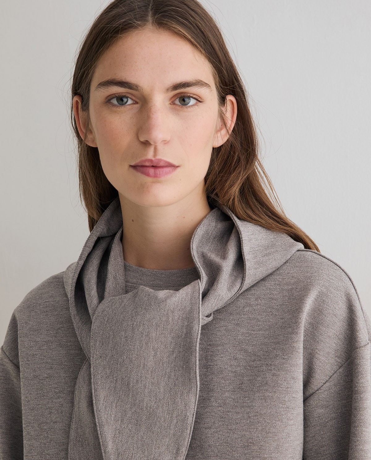 Sudadera oversize con capucha extraíble en color gris, vista frontal con detalle del tejido interlock 1